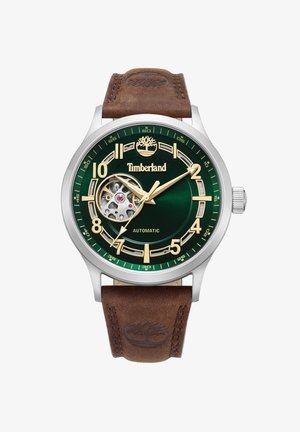 Green watch with automatic movement, stainless steel case, gold accents, large numerals, and brown leather strap with logo embossed.
