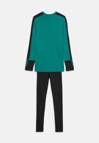 Teal long-sleeve top with black accents and stripes on sleeves, paired with black leggings. Fabric appears smooth and lightweight.