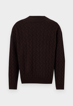 Tumši brūns adīts džemperis ar bārkstainu rakstu, ribotām apkaklītēm un piedurknēm. Tam ir garas piedurknes un nedaudz brīva piegriezuma forma.