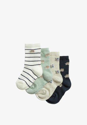 Vier paar babysokken in wit met zwarte strepen, saliegroen, beige met blauwe bloemen en marineblauw, elk met kleine egelpatronen.