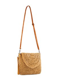 Woven straw handbag with a curved flap, tan leather strap, and light brown finish, featuring textured patterns for added detail.
