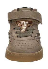 Beige suede sneakers met een bruine rubberen zool, grijze veters, metalen koperen tong, klittenbandsluiting en decoratieve glinsterdetails aan de zijkanten.