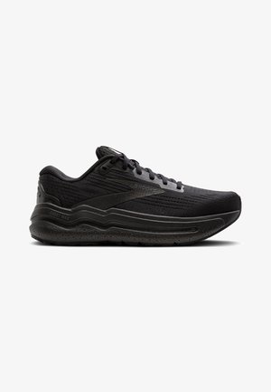 Black running shoes with a textured mesh upper, cushioned sole, and minimalist design. Features laces and a subtle logo on the side.