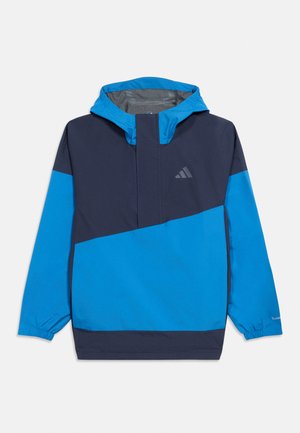 Chaqueta tipo pulóver azul y azul marino con capucha, puños elásticos, bloque de color diagonal y pequeño logo de Adidas en el pecho.