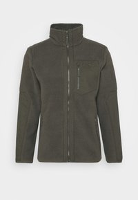 Polarowa kurtka w ciemnozielonym kolorze z wysokim kołnierzem, pełnym zamkiem, kieszenią na lewym froncie oraz teksturowanym materiałem. Posiada wzmocnione panele na ramionach i bokach.