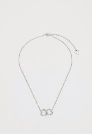 Silver necklace with a delicate chain, featuring an infinity symbol made of two intertwined hearts with small embedded stones.