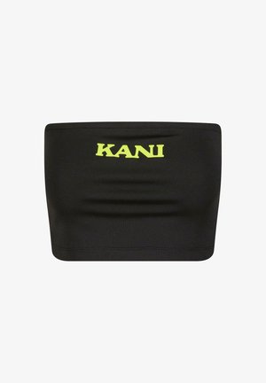 Černý top bez ramínek vyrobený z elastického materiálu, který má uprostřed velké neonově žluté logo "KANI". Hladký povrch s minimálním počtem švů.