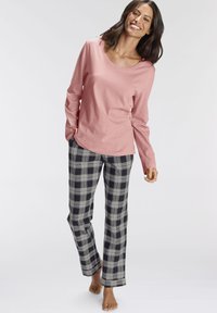 Light pink long-sleeve top with a round neckline paired with black and white plaid pajama pants, featuring a relaxed fit and soft texture.
