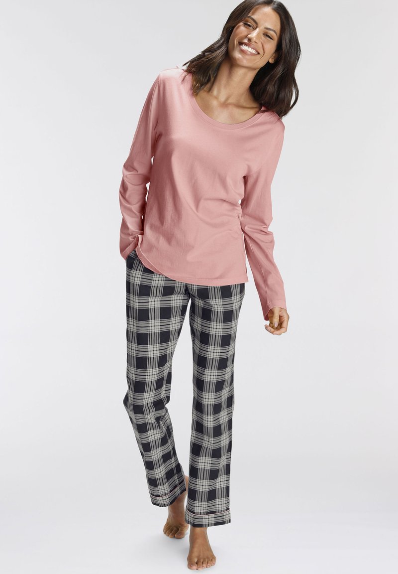 Light pink long-sleeve top with a round neckline paired with black and white plaid pajama pants, featuring a relaxed fit and soft texture.