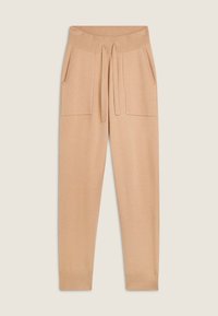 Pantalones de chándal beige hechos de una tela suave, con una cinturilla acanalada, cordón de ajuste y dos bolsillos frontales, con un corte relajado.