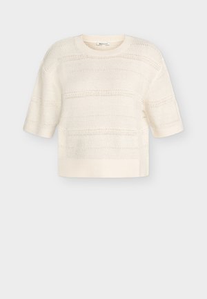 Īss piedurkņu krēmkrāsas trikotāžas džemperis ar apaļu izgriezumu un horizontālām caurumu joslām, attēlots uz vienkārša fona.