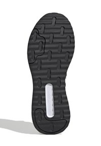 Suela de zapato de goma negra con patrón de agarre texturizado y un detalle de logo blanco. Presenta una línea curva y recortes rectangulares para mayor flexibilidad.