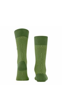 Zielone skarpetki z geometrycznym, zygzakowatym wzorem w różnych odcieniach zieleni. Ściągacze i gładka tekstura zapewniają wygodę.
