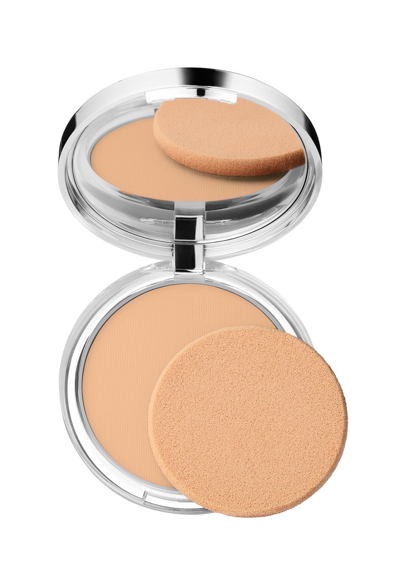 Kompaktpulver med et klart, rundt etui, som har beige pulver og en rund, myk applicatorsvamp på toppen.