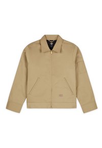 Veste beige à fermeture éclair avec col, deux poches avant, petit patch logo près de l'ourlet et manches longues avec un patch sur le bras gauche.
