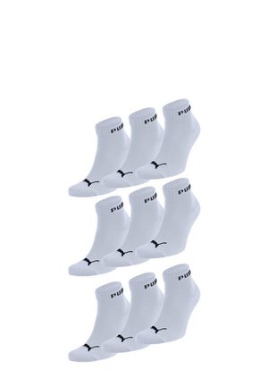 White ankle socks made of cotton blend, featuring a black PUMA logo and band, presented in a stacked arrangement.