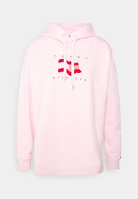 Felpa rosa chiaro con coulisse, caratterizzata da un logo centrale di bandiere rosse e bianche. Realizzata in materiale morbido, con polsini e orlo a coste.