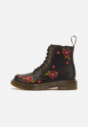 Botte en cuir noir à lacets avec semelle marron, ornée d'une broderie florale rouge et rose, avec une languette à l'arrière.