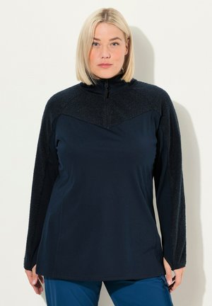 Marine blauwe fleece pullover met ritssluiting, een gestructureerde bovenkant, een gladde body, lange mouwen en een hoge kraag. Voorzien van contrasterende materialen en naden.