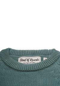 Stickad tröja i ekologisk bomull i teal, med en ribbad rundhals och texturmönster. Etiketten säger "Band of Rascals."
