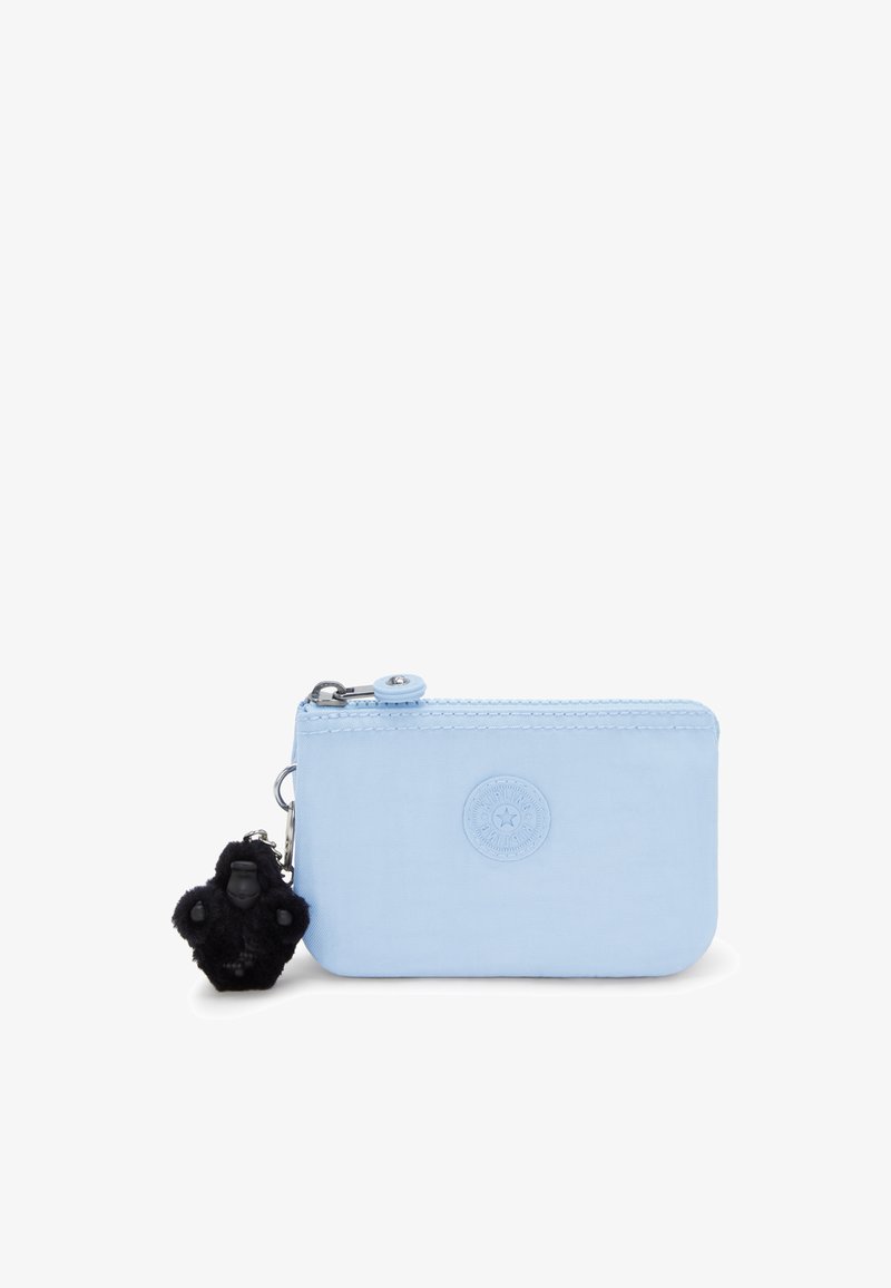 Light blue zippered wallet made of smooth material, featuring a circular logo and a fuzzy black gorilla keychain charm attached.