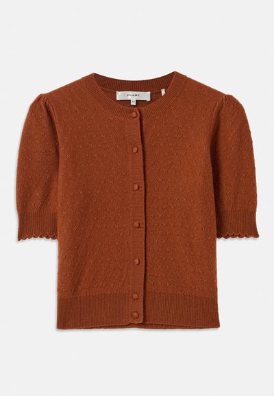 Short-sleeve cardigan in rust-colored knit fabric. Features a round neck, button front, textured pattern, and scalloped sleeve hems.