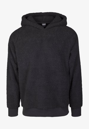 Zwarte, zachte fleece hoodie met een gestructureerd oppervlak, raglanmouwen en geribbelde manchetten. Beschikt over een brede capuchon en een rechte zoom.