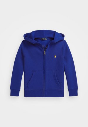 Blue zip-up hoodie with a large hood, front pockets, and a small yellow logo on the chest. Made of soft, textured fabric.