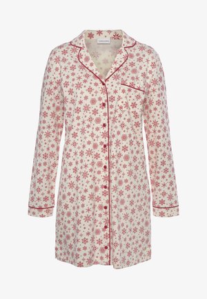 Langärmliges Schlafanzugoberteil aus weißer Baumwolle mit roten Schneeflockenmuster, rotem Piping am Kragen, mit Knöpfen und einem kleinen Brusttaschendetail.