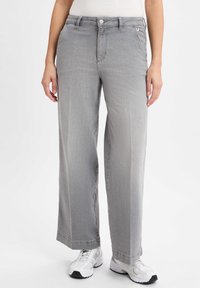 Gray wide-leg jeans with a smooth texture, classic five-pocket design, and a button closure at the waist, paired with white athletic shoes.