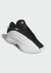 Scarpe sportive in bianco e nero con tomaia in rete, collare imbottito, lati sintetici lisci e dettagli perforati sulla soletta intermedia.