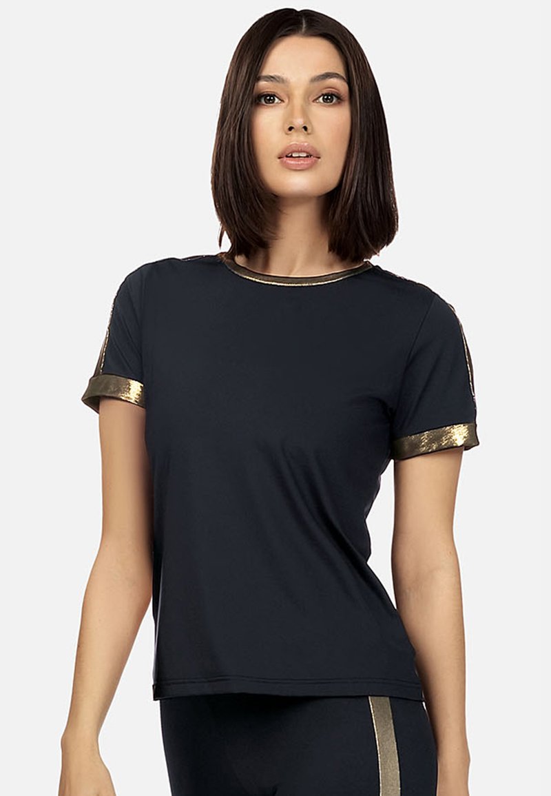 Czarny t-shirt z krótkim rękawem z złotymi metalicznymi akcentami na rękawach i dekolcie. Zaprojektowany w luźnym kroju i o miękkiej fakturze.