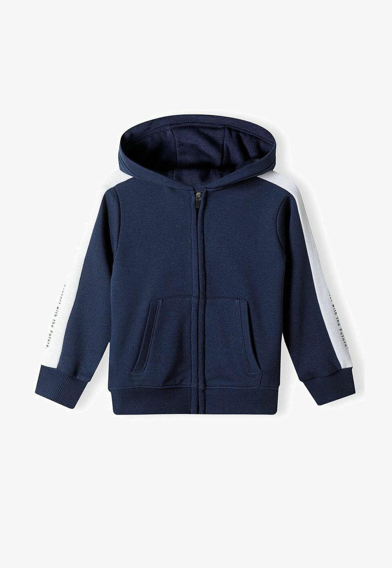 Mörkblå zip-up hoodie med vita sidopaneler, framfickor, ribbade ärmar och kapuschong med snöre. Tillverkad av mjukt, strukturerat tyg.