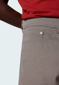 Gray textured trousers with front pockets and silver hardware details. The waistband is flat, showcasing a smooth finish.
