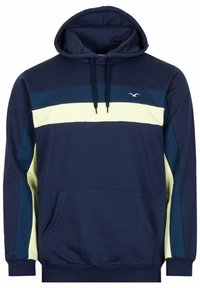 Felpa blu navy con strisce orizzontali giallo chiaro e blu scuro, tasca a marsupio, cappuccio con cordino e piccolo logo di un uccellino bianco sul petto.