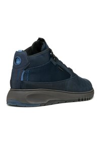 Zapatillas altas de color azul oscuro con un diseño de cuero suave y malla, acentos texturizados y una suela de goma flexible.