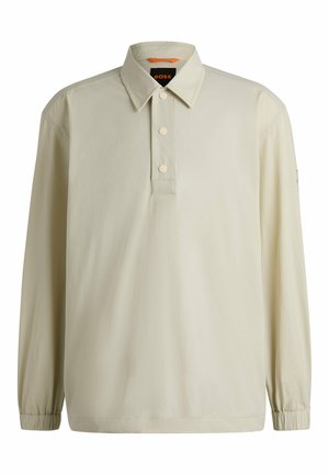 Light beige long-sleeve polo shirt with a collar, three-button placket, elasticized cuffs, and logo detail on the sleeve. Smooth fabric texture.