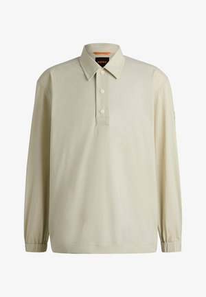 Lichtbeige polo shirt met lange mouwen, een kraag, een drieknoopsluiting, elastische manchetten en logodetail op de mouw. Gladde stoftextuur.