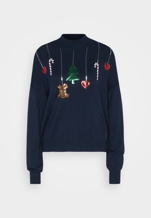 Navy blue sweater with a high neck, featuring sequin holiday decorations: a tree, hearts, candy canes, and a reindeer, all on a curved design.