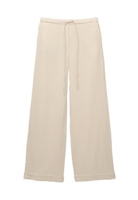 Vida byxor i mjuk beige tyg, med en texturerad yta, elastisk midja med snöre, och avslutade fållar.