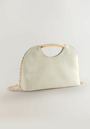 Mīksti zaļš somiņa ar krokodila ādas faktūru, noapaļotu augšdaļu, zelta krāsas rokturi un ķēdes siksnu. Plakana apakša stabilitātei.