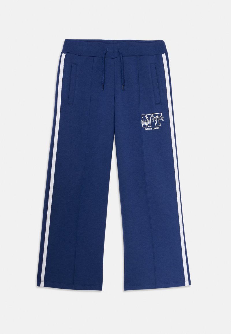 Námořnické tepláky s volným střihem, bílé boční pruhy, stahovací pás a potisk "NY Varsity League" na levém stehně.