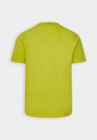 T-shirt a maniche corte in cotone verde lime brillante, con scollatura tonda e taglio dritto, con cuciture uniformi e senza fantasie.