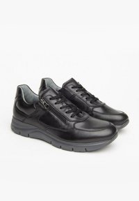 Zapatos de cuero negro con un diseño elegante, que cuentan con un cierre de cordones en la parte delantera, detalle de cremallera lateral y una suela de goma acolchada.