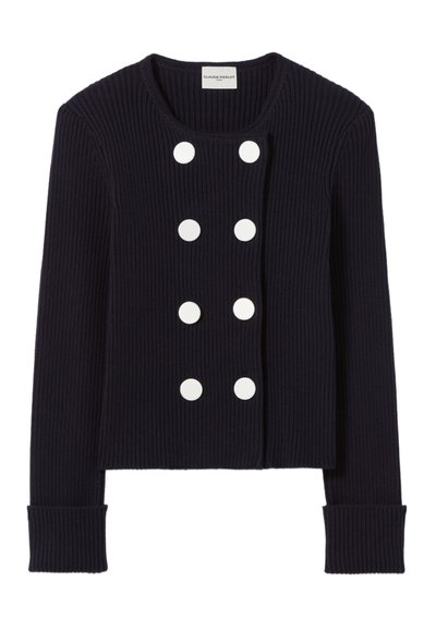 Veste bleu marine à côtes avec un col rond, fermeture à boutons sur le devant comportant six grands boutons blancs, et larges poignets.