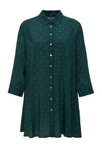 Blusa verde scuro con collo a camicia, maniche lunghe e chiusura a bottoni frontale. Presenta un piccolo motivo geometrico ripetuto su tutta la superficie.