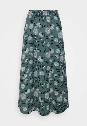 Maxirok met bloemenprint in teal stof met grote witte bloemen en zwarte bladeren. Elastische tailleband; vloeiende A-lijn vorm.
