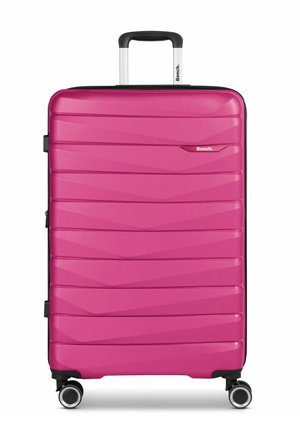 Pink polycarbonate suitcase with horizontal ridges, retractable handle, and four 360-degree spinner wheels for easy maneuverability.