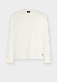 Λευκό ριγωτό πουκάμισο με μακριά μανίκια, στρογγυλή λαιμόκοψη και εφαρμοστά τελειώματα στα μανίκια. Διαθέτει μικρή ετικέτα με λογότυπο στο κάτω αριστερό μέρος. Απαλή υφή.