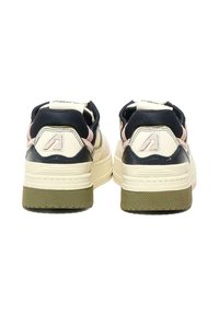 Sneaker con parte superiore crema, accenti blu scuro e dettagli rosa. Suola in gomma verde a motivo waffle spesso. Logo sul retro visibile.